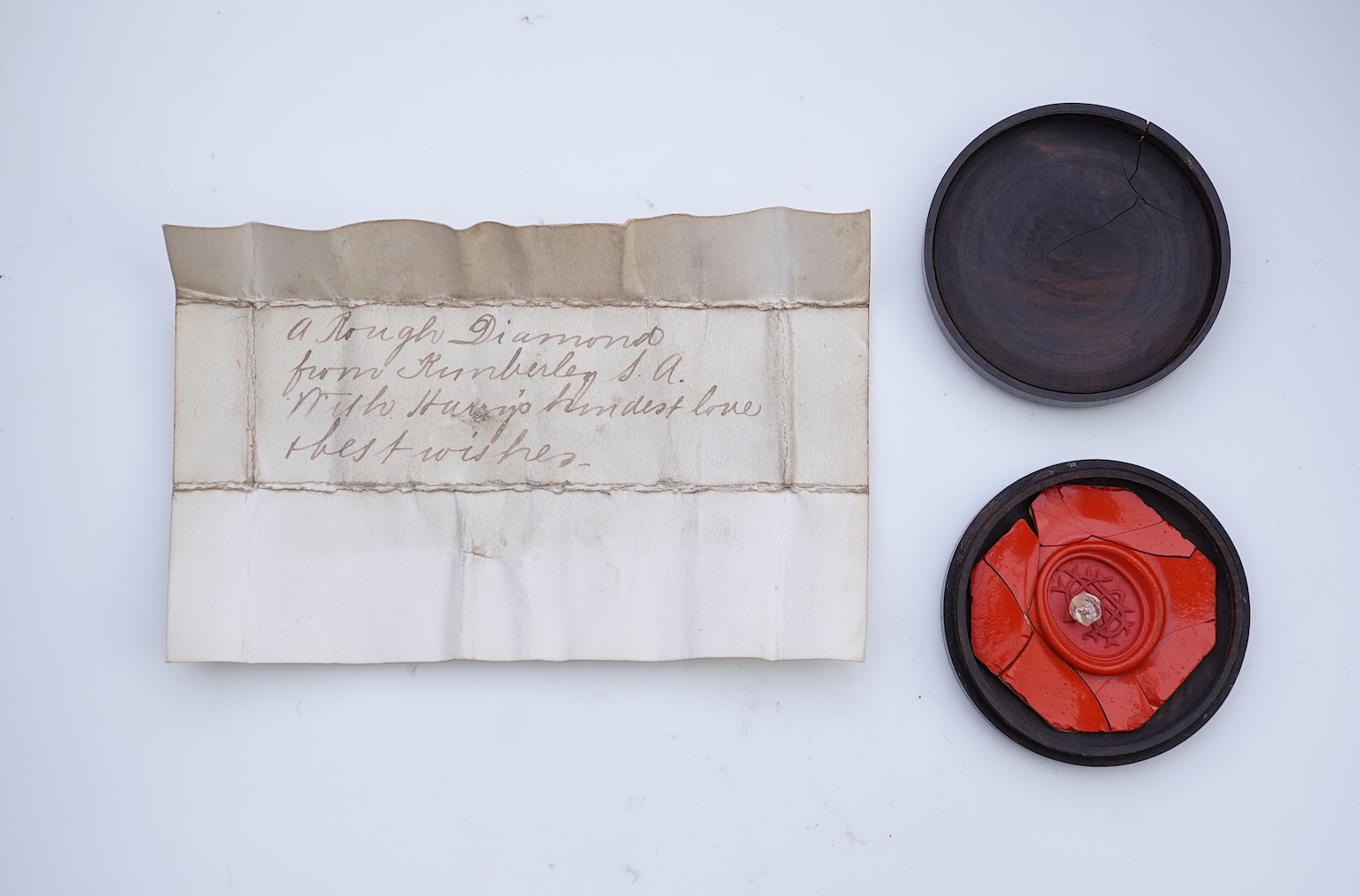 A rough diamond, with accompanying box and note, late 19th century